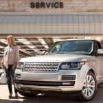Woman speaking with a technician at a Land Rover service center