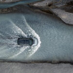 A Land Rover model driving through a river