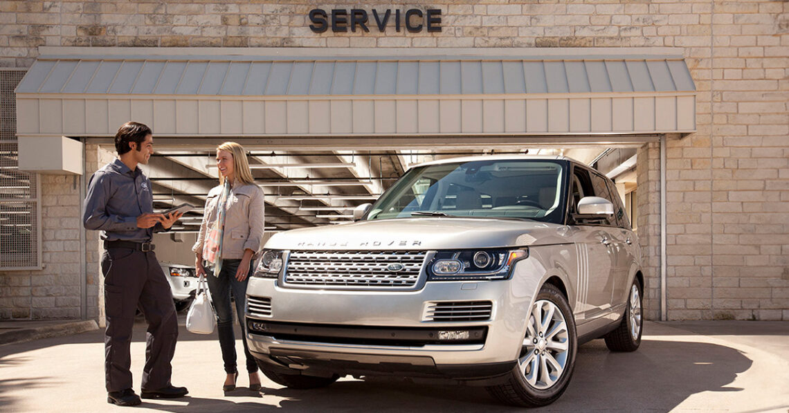 Woman speaking with a technician at a Land Rover service center